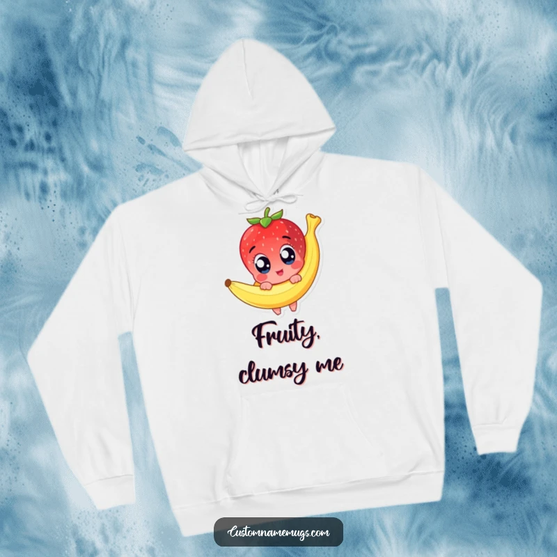 Funny hoodie featuring a cute strawberry character with wide, shocked eyes mid-slip on a banana peel, conveying hilarious cartoonish misfortune.