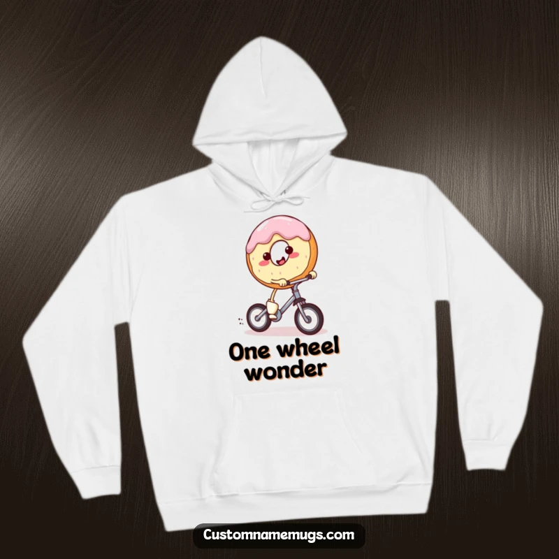 Funny hoodie with a smiling, round donut character with tiny legs enthusiastically riding a miniature unicycle. Cozy and humorous apparel.