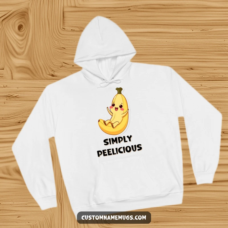 Funny Kawaii banana character in an ecstatic slide down its peel, featured on a cozy hoodie, ideal for gifting.