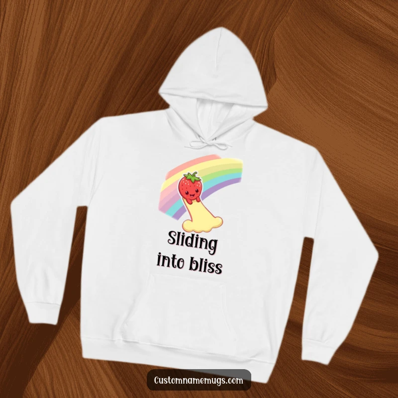 Funny hoodie depicting a smiling strawberry character dramatically sliding down a rainbow, offering warmth and whimsical, fruity vibes.