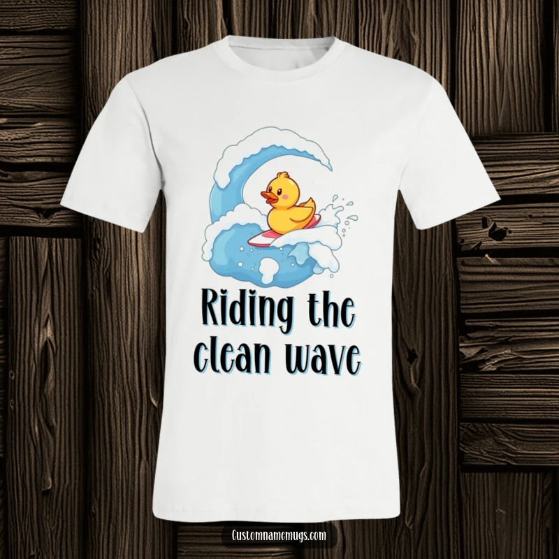 Funny T-Shirt: Determined tiny rubber ducky character bravely surfing a massive bubbly wave made entirely of soap.