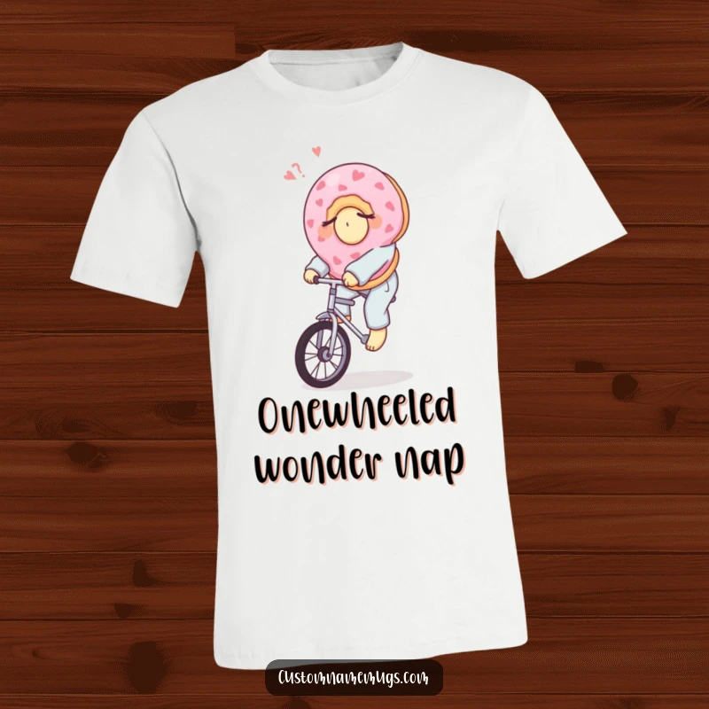 Funny t-shirt with a sleepy donut in pajamas riding a unicycle, representing morning efforts and sweet, humorous vibes.