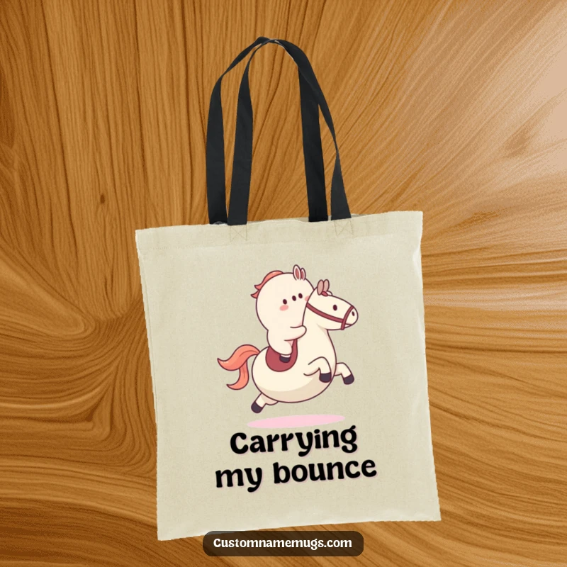 Funny tote bag showcasing a small blob character riding a large bouncy ball like a horse, great for carrying items with a smile.